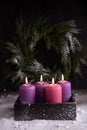 Four Christmas burning pink and purple advent candles Royalty Free Stock Photo
