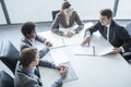 Four business people sitting around a table and having a business meeting, high angle view Royalty Free Stock Photo