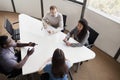 Four business people sitting at a conference table and discussing during a business meeting Royalty Free Stock Photo