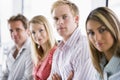 Four business people sitting indoors smiling Royalty Free Stock Photo