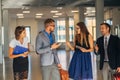 Four business people talking in office lobby Royalty Free Stock Photo