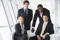 Four businesspeople in office lobby Royalty Free Stock Photo