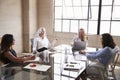 Four businesswomen in discussion in a meeting room