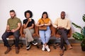 Four candidates sitting in a row waiting for job interview, creative tech coder
