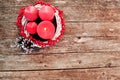 Four candles in a white wreath with red berries on a wooden rustic background. advent calendar for Christmas Royalty Free Stock Photo