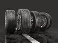 Four car tires rolling on a road. Royalty Free Stock Photo