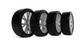 Four car tires with silver rims standing in row on white background Royalty Free Stock Photo