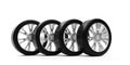 Four car tires with silver rims standing in row on white background Royalty Free Stock Photo