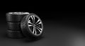 Four car wheels on black background. 3D rendering illustration. Royalty Free Stock Photo