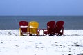 Four chairs on a snowy beach Royalty Free Stock Photo