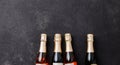 Four champagne bottles on dark background, flat lay Royalty Free Stock Photo
