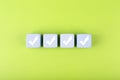 Four checkmarks on white cubes against bright green background