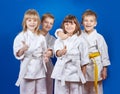 Four cheerful sportsman in karategi are showing finger super Royalty Free Stock Photo