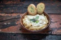 Four cheese pasta with garlic bread on rustic wooden background