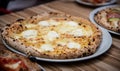 Four cheese pizza Quattro Formaggio on wooden table, Italian cuisine