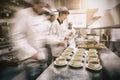 Four chefs working in a modern kitchen Royalty Free Stock Photo