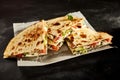 Four chicken quesadilla slices on dark table Royalty Free Stock Photo
