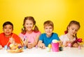 Four children colour Easter eggs at the table Royalty Free Stock Photo