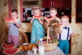 Four children eat fruit in the kitchen. Photo in retro style Royalty Free Stock Photo