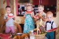 Four children eat fruit in the kitchen. Photo in retro style Royalty Free Stock Photo
