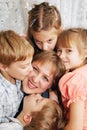 Four children kissing mother. Family concept