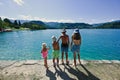 Four children in panamas stand in pier of view beautiful Bled Lake, Slovenia