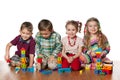 Four children are playing on the floor