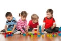 Four children are playing on the floor