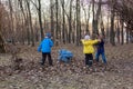 Four children playing with last year foliage in park