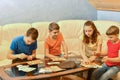 Four children are playing a lotto board game