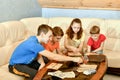 Four children are playing a lotto board game