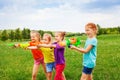 Four children playing with water guns Royalty Free Stock Photo