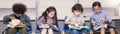 Four children reading on a chair in the classroom