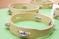 Four children`s wooden tambourines with metal bells Royalty Free Stock Photo