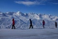 Four Children Walking next to a Tall Snow Drift