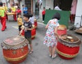 Four Chinese children playing drums on a street at a Chinese New Year festival