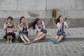 Four chinese females applying make-up