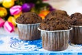 Four chocolate muffins on a background of tulips Royalty Free Stock Photo