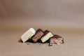 Four chocolate protein bars with different flavors in the context of sprinkle rice flakes on baking paper, Teflon paper. Whey prot Royalty Free Stock Photo