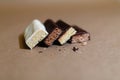 Four chocolate protein bars with different flavors in the context of sprinkle rice flakes on baking paper, Teflon paper. Whey prot Royalty Free Stock Photo