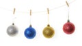 Four Christmas balls hanging on small wooden clothespins in a row Royalty Free Stock Photo