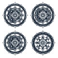 Four circular compass rose designs with intricate details in black and white on a white background Royalty Free Stock Photo