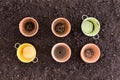 Four clay pots and two metal ones in rows of three Royalty Free Stock Photo