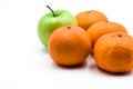 Four clementines and green apple isolated on a white Royalty Free Stock Photo