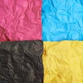 Four CMYK colored paper sheets