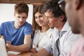 Four colleagues work together at a laptop computer, close up Royalty Free Stock Photo