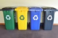 Generative AI. Four color-coded recycling bins lined up against a wall, each marked with recycling symbols Royalty Free Stock Photo