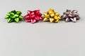 Four color festive bows over grey background Royalty Free Stock Photo