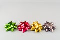 Four color festive bows over grey background Royalty Free Stock Photo