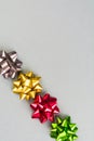 Four color festive bows over grey background